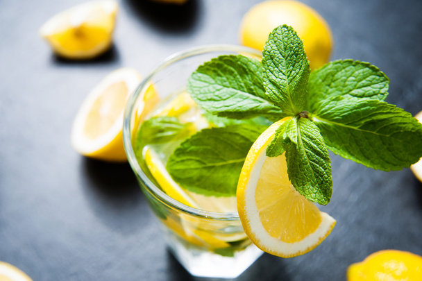 Refreshing cold lemonade on dark stone table - Foto, Imagen