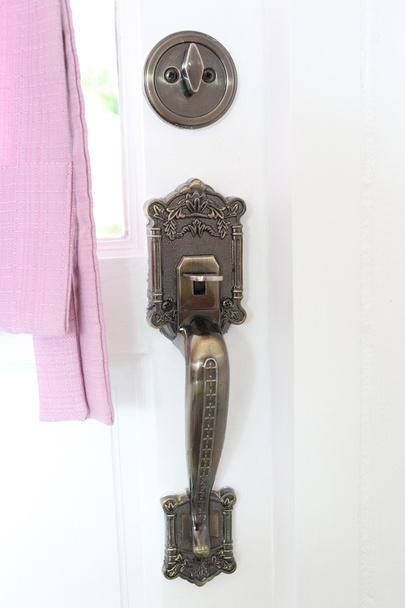Vintage handle of room door with interior decoration. - Photo, Image