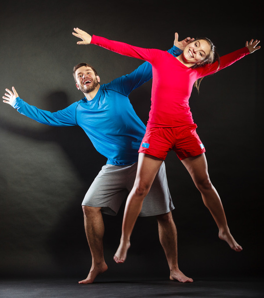 Happy young couple man and woman jumping for joy. - Fotó, kép