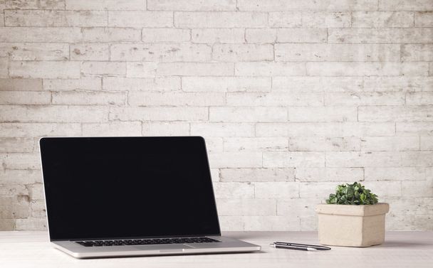 Business laptop with white brick wall - Valokuva, kuva
