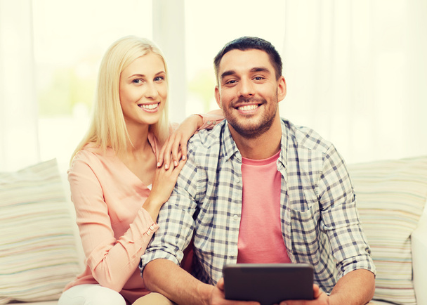 smiling happy couple with tablet pc at home - Fotoğraf, Görsel