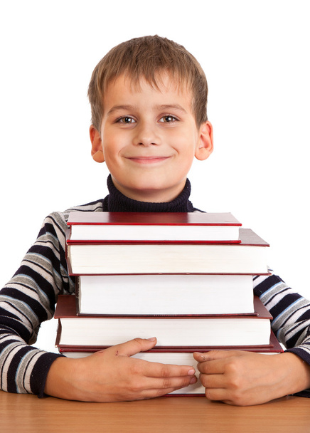 Schoolboy and a heap of books isolated on a white background - Foto, Imagem