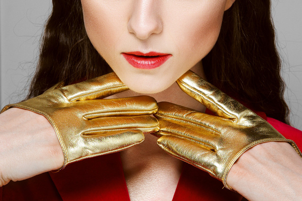 pretty fashion model in golden mini gloves posing - Fotoğraf, Görsel
