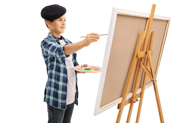 Little kid painting on a canvas  - Фото, изображение