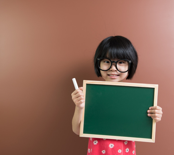 Asian school kid with chalk and chalkboard - Photo, Image