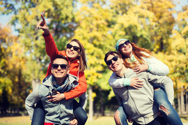 happy friends in shades having fun at autumn park - Фото, зображення