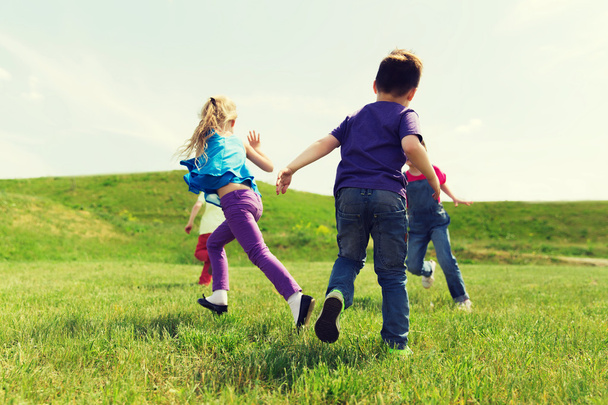 group of happy kids running outdoors - 写真・画像