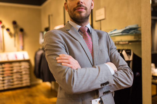 close up of man in suit and tie at clothing store - Photo, Image