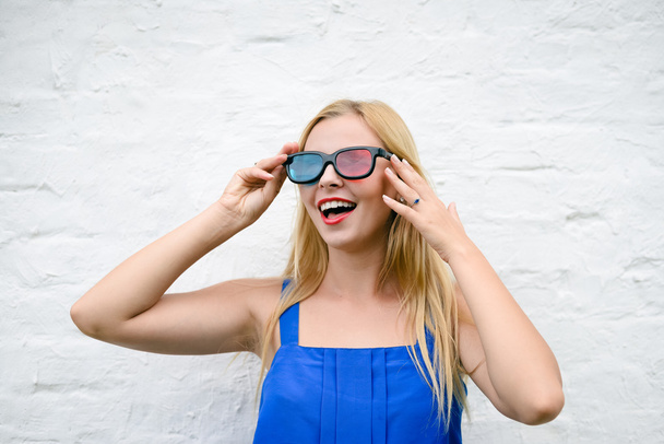 Beautiful young woman watching movie with 3D glasses, exciting holding hands - Foto, Bild