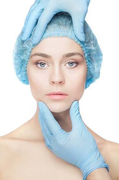 Plastic surgery concept. Doctor hands in gloves touching woman face - Fotografie, Obrázek