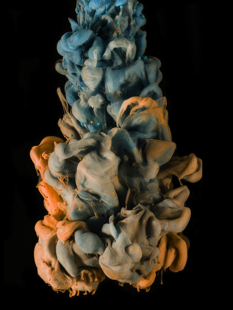 Colorful ink under water. Artistic abstract design isolated on black background. - 写真・画像
