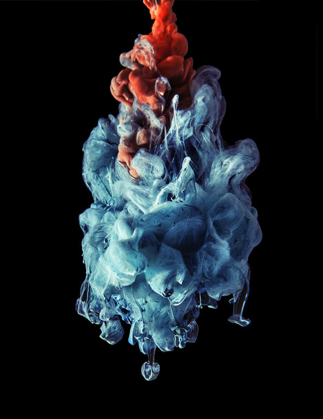 Colorful ink under water. Artistic abstract design isolated on black background. - Foto, Imagem