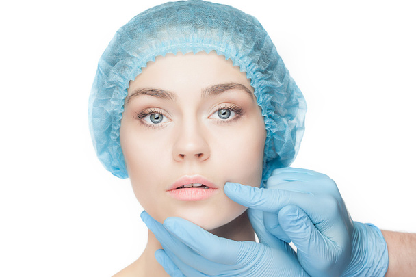 Plastic surgery concept. Doctor hands in gloves touching woman face - Valokuva, kuva