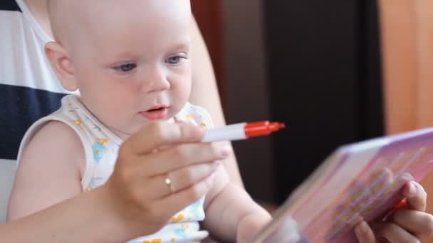 Boy learning handwriting practice from mother - Materiał filmowy, wideo