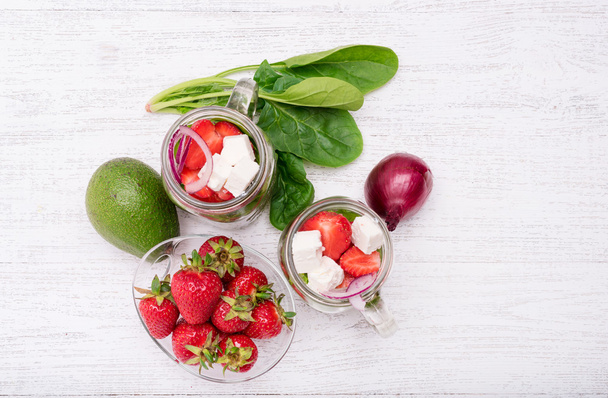 Homemade salad with spinach, strawberry and cheese in glass jar.  - 写真・画像