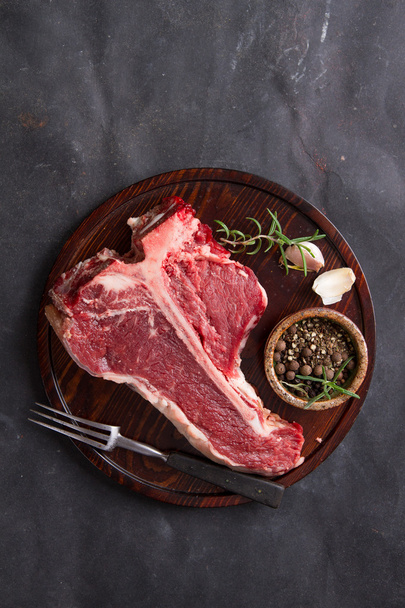 Thick raw T-bone steak with seasoning - Fotó, kép