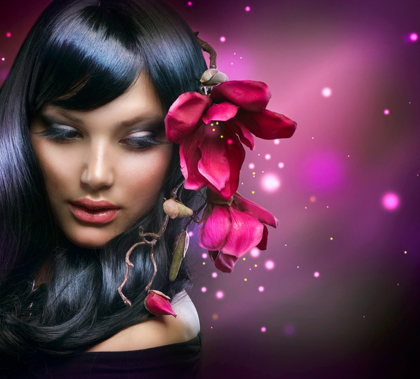 Fashion Brunette Girl with Magnolia Flowers - Фото, зображення