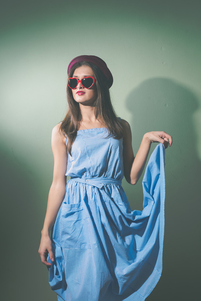 Beautiful elegant girl with sunglasses and hat on light background  - Fotografie, Obrázek