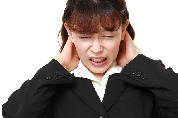 Asian businesswoman suffers from neck ache - 写真・画像