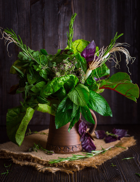 Bouquet of fragrant herbs in a clay jug - 写真・画像