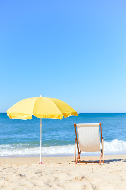 Chair and umbrella on stunning tropical beach background vacation - Fotó, kép