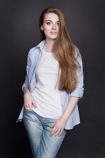 Stylish young girl in denim clothes. She is cheerful and energetic - Fotografie, Obrázek