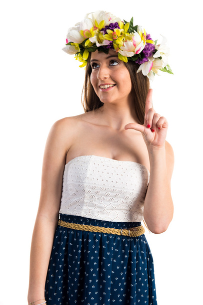Girl with crown of flowers pointing up - 写真・画像