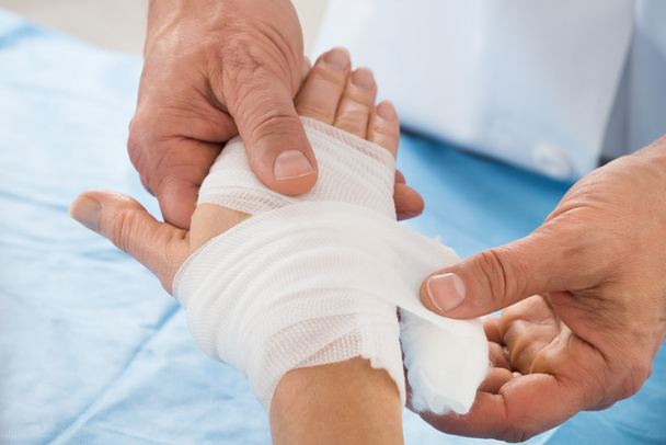 Person Wrapping Bandage To Patient - Fotó, kép