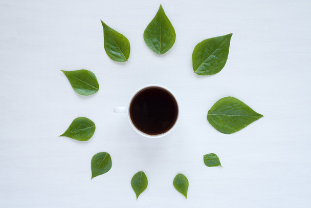 Black coffee and green leaves - Φωτογραφία, εικόνα