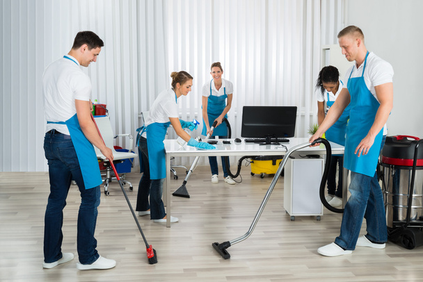 Group Of Janitors Cleaning Office - 写真・画像