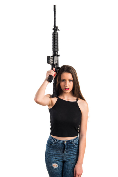 Jong meisje die houdt van een geweer - Foto, afbeelding