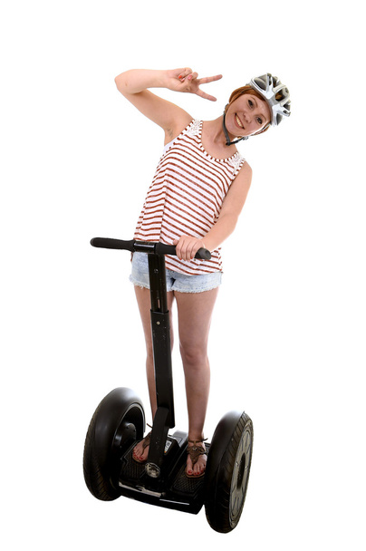 young tourist woman wearing safety helmet doing peace hands sign smiling happy riding electrical segway - Foto, afbeelding
