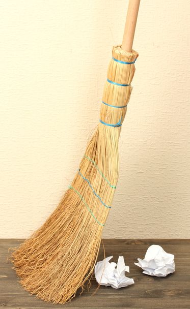 Broom and papers on floor in room - Foto, immagini