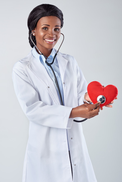 Female doctor holding a red heart  - Fotó, kép