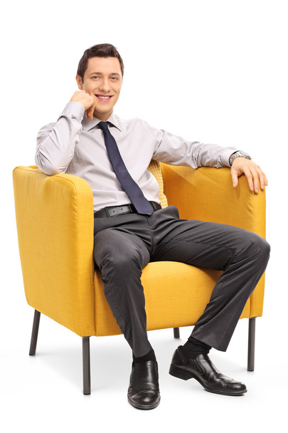 Confident businessman sitting in armchair  - Φωτογραφία, εικόνα