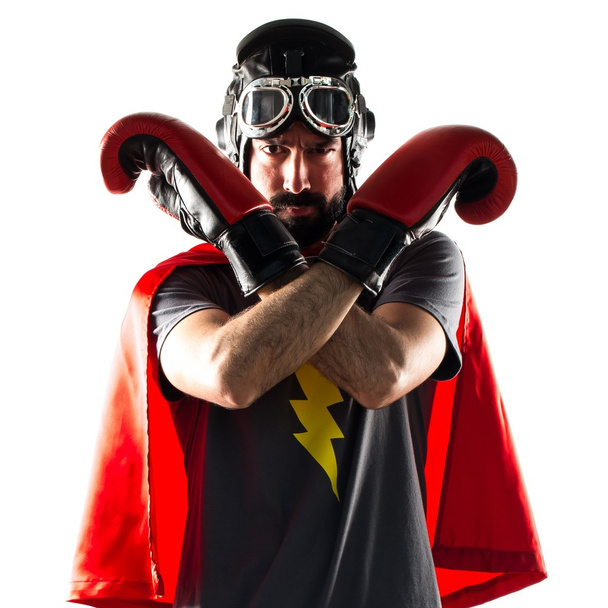 Супергерой в боксерских перчатках делает знак "стоп"
 - Фото, изображение