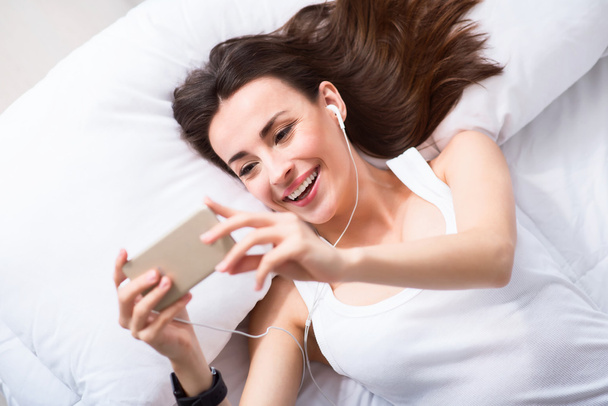 Delighted  beautiful woman resting in bed - Photo, image