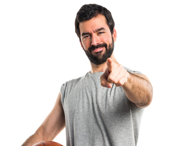Man playing basketball pointing to the front - Fotó, kép