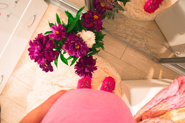 Pregnant woman with pink peonies. Top overview - Photo, Image