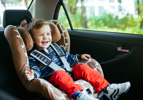 Adorable baby boy in safety car seat.  - Fotó, kép