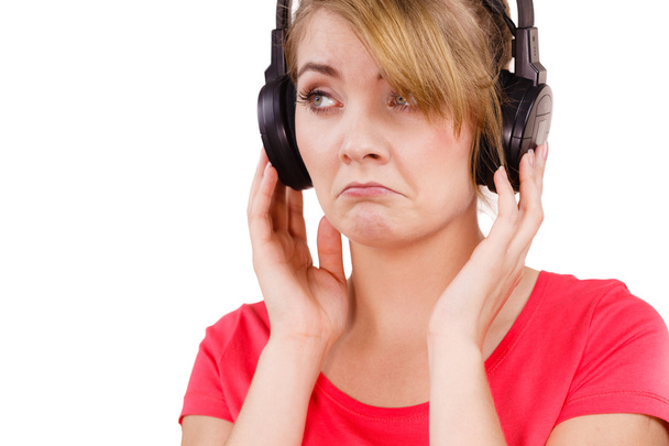 Woman sad girl in big headphones listening music - Valokuva, kuva