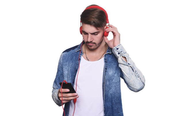 Young man listening to music with smartphone - Φωτογραφία, εικόνα