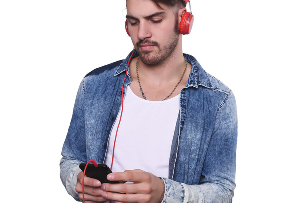 Young man listening to music with smartphone - Fotoğraf, Görsel