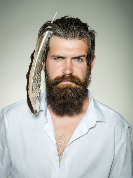 Bearded man with feather in hair - Fotoğraf, Görsel