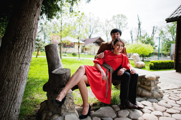 Couple sitting on bench. Stylish man at velvet jacket and girl i - Fotografie, Obrázek
