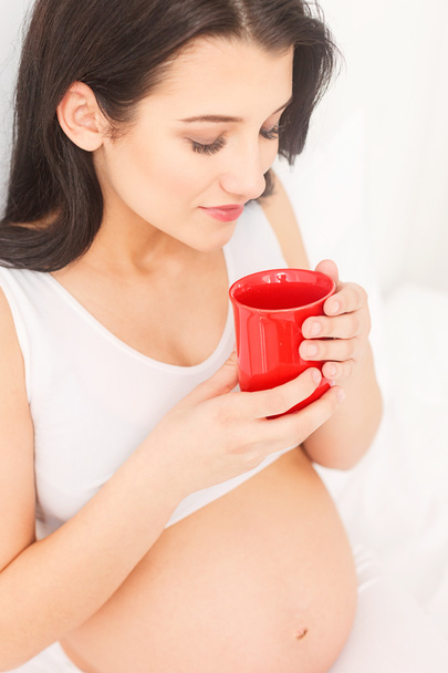 Pretty expectant mother is relaxing with beverage - Foto, immagini