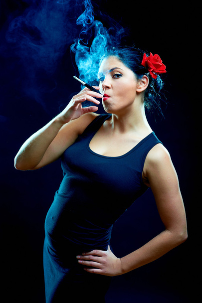 Sexy looking spanish women smoking cigarette - Zdjęcie, obraz