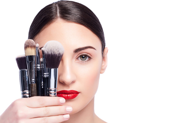 Beautiful healthy girl is carrying cosmetic tools - 写真・画像
