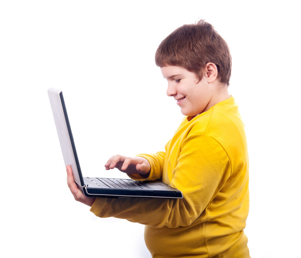Happy chubby adolescent garçon travaillant sur ordinateur portable isolé sur blanc
 - Photo, image