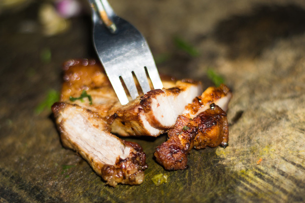 Roasted pork on old cutting board with fork - Photo, Image
